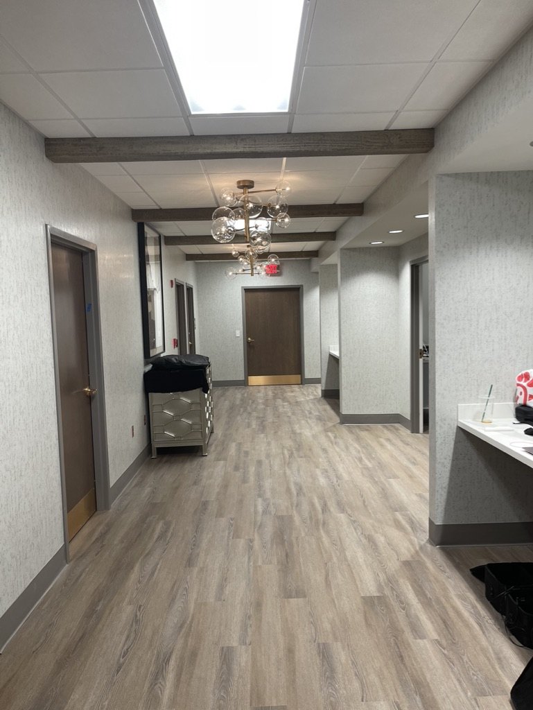 Modern medical practice interior — hallway with statement lighting
